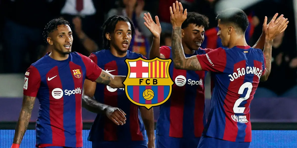 The FC Barcelona players celebrate together after a goal is scored and the FC Barcelona badge is in the middle.