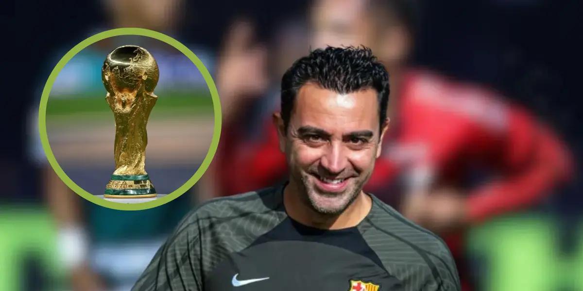 Xavi sonríe, a su derecha la Copa del Mundo.